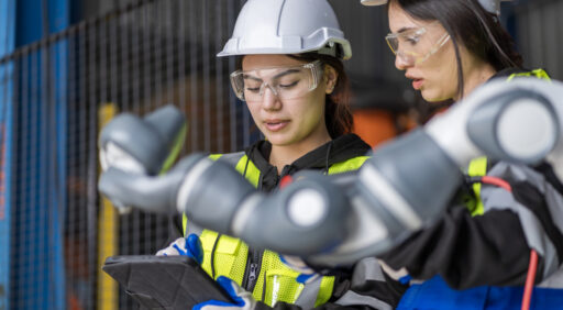 A team of female engineers meeting to inspect computer-controlled steel welding robots. Plan for rehearsals and installation for use.