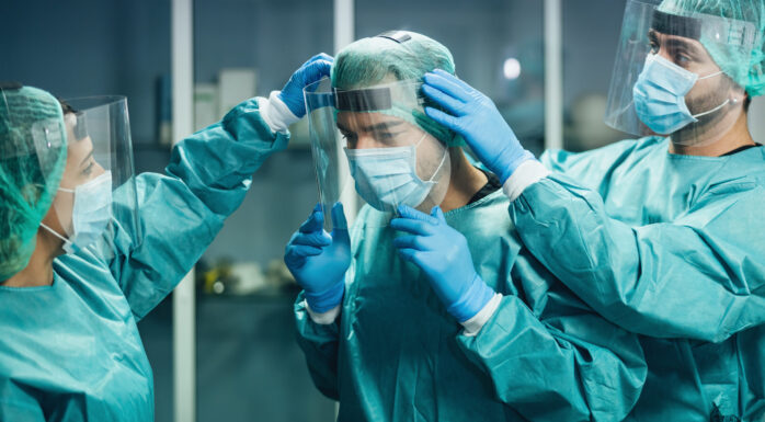 Doctors wearing ppe equipment face surgical mask and visor fighting against corona virus outbreak - Health care and medical workers concept